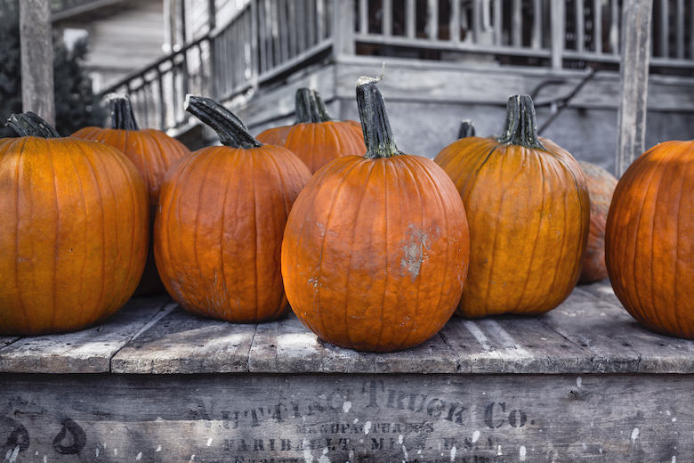 Pumpkins sitting on a porch