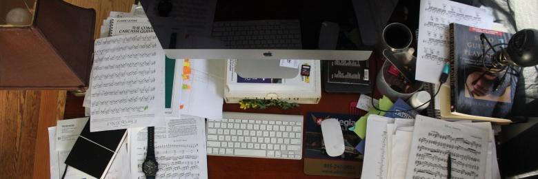 Cluttered desk with paper and computer