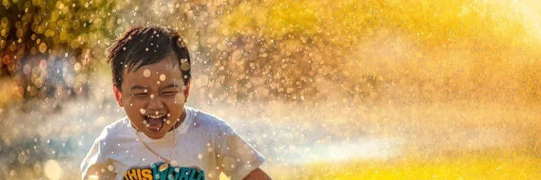 Kid playing with a sprinkler