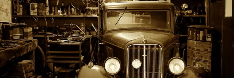 An antique car inside of a garage
