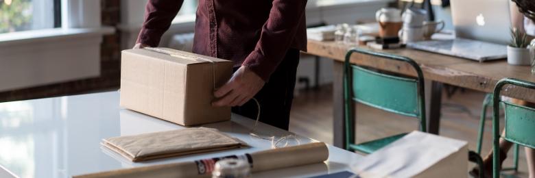 Person packing a box