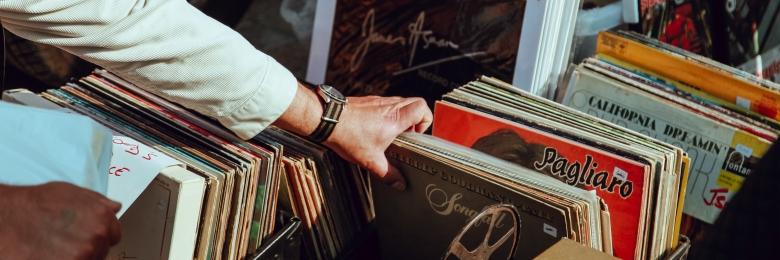 Person sorting through a record collection