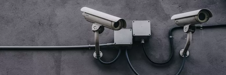 Security cameras on a grey wall