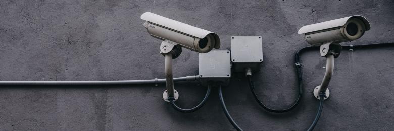 Security cameras on a grey wall