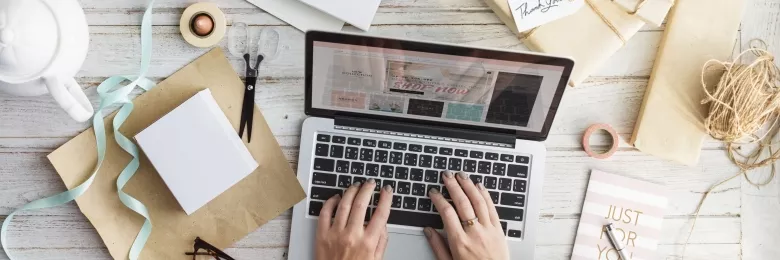 Woman typing on a laptop keyboard