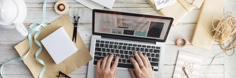 Woman typing on a laptop keyboard