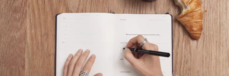 Person writing in an agenda