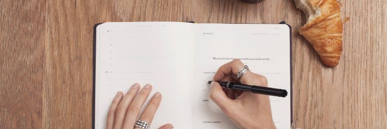 Person writing in an agenda