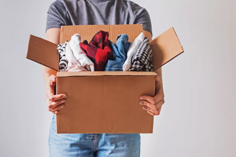 Person holding box of clothing
