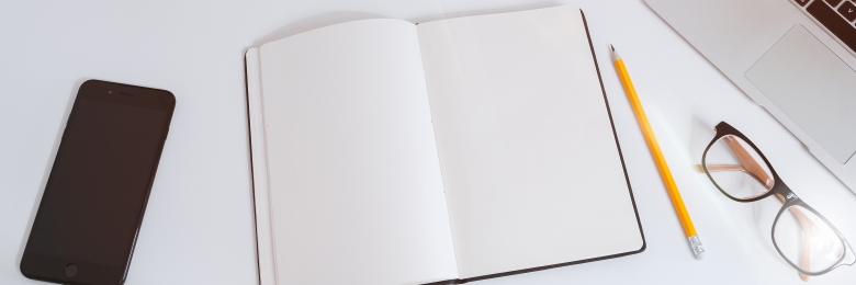 A notebook and pencil on a table